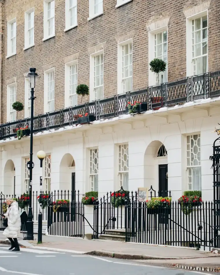 Georgian townhouses with black iron balconies and window boxes